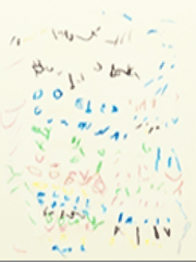 A child's Level 2 writing in multiple colors on a piece of paper.
