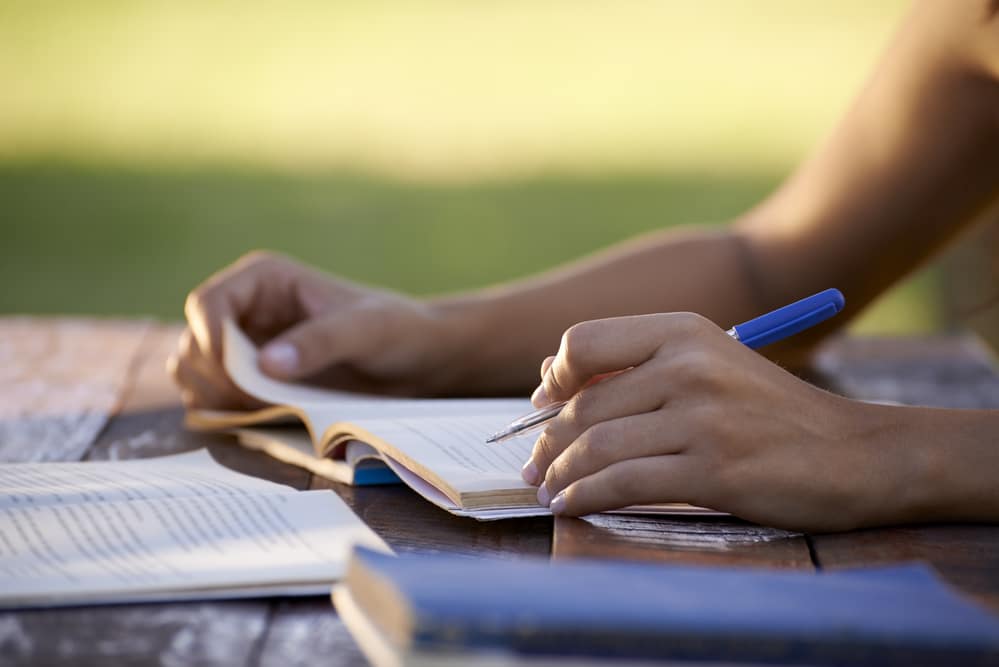 womanstudyingoutside1000x667 Building Wings Building Wings Women studying on a picnic table outside