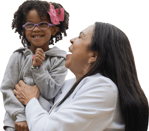 A women wearing a white shirt holds a child in her arms as they both laugh happily