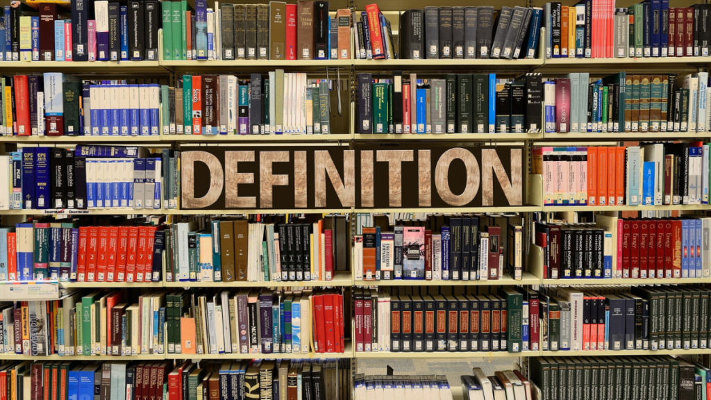 Bookcase with many shelves filled with books of various colors. In an area on a middle shelf is the word Definition.