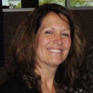 ruth ziolkowski headshot Photo of a woman with shoulder-length wavy brown hair smiling toward the camera