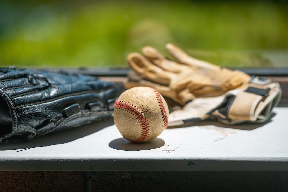 A baseball and several baseball mitts that students can touch and feel when gaining background knowledge about baseball.