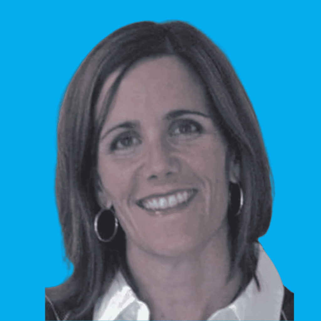 Smiling woman with shoulder-length brown hair and hoop earrings against a bright blue background.
